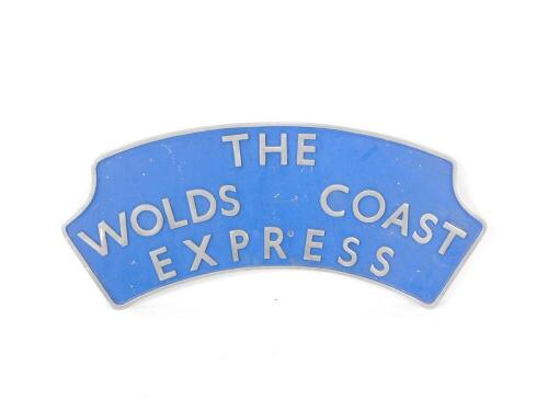 A replica The Wolds Coast Express blue and grey painted cast metal train name plate, 46cm H x 102cm W.