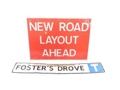 A New Road Layout Ahead road sign, red background with white lettering, 76cm H x 106cm W, together with a Foster's Drove road sign, 23cm H x 145cm W. (2)