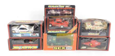 Five Scalextric model racing cars, comprising Cosworth Texaco C455., BMW 318i C571., Ferrari F1 C457., Porsche, red with working head and brake lights C427., and a Ford Cosworth C456, further Scalextric car and a Matchbox SCX Mercedes Truck 'BP', all bo