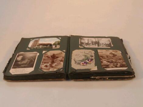 An early 20thC postcard album containing approximately two hundred and fifty cards