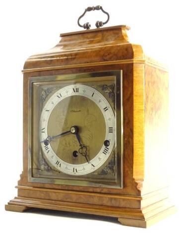 A walnut cased Elliott mantel clock, with a brass and silvered dial and with name of retailer J Hopper Limited, with Westminster chime, highly figured case, with detailed instructions from the Elliott Clock Company to the inside of the door, 31cm H.