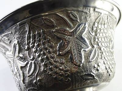 A large early 20thC plated punch bowl, the compressed bell shaped body, repousse decoration with a repeat pattern of berries, and leaves, on a circular foot, with traces of gilt to the interior, unmarked, 20cm H. - 2