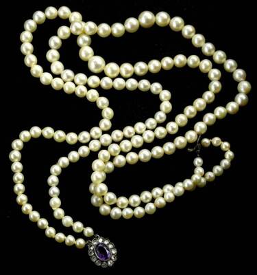 A cultured pearl two strand necklace, with a silver and marcasite clasp, with central purple stones, surrounded by white stones, 42cm L overall.