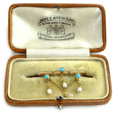 A Victorian 9ct gold bar brooch, set with three turquoise stones, and with seed pearl v shaped drop, set with three seed pearls, marked to rear BHJ 9c, in a James Aitchison Jewellers of Edinburgh box, 1.6g all in, 3.5cm W.