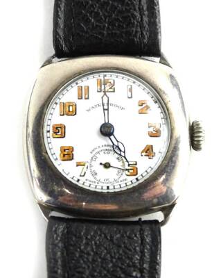 A silver cased gents wristwatch, inscribed to back Captain R.F. Curtis RA 93613 C of E, and numbered 3630945, with a white enamel dial, and orange/brown coloured numbers, seconds dial, 3cm W, on black leather strap, movement stamped 4032752.