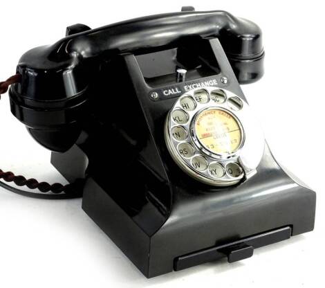 A 20thC black Bakelite telephone, with chrome plated articulated front dial and drawer, with shaped receiver, the main body 18cm H.