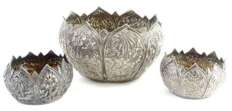 Three eastern white metal bowls, each decorated with birds, animals, palm trees, etc., probably Burmese, 6½oz.