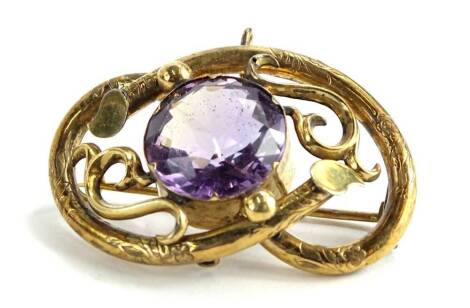 A Victorian twist design brooch, with circular amethyst set stone, with floral engraved sides, yellow metal unmarked, 4cm W, boxed.