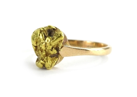 A golden nugget dress ring, the central nugget design, on a later plain band, yellow metal, stamped 15k, ring size L, 3.7g all in.