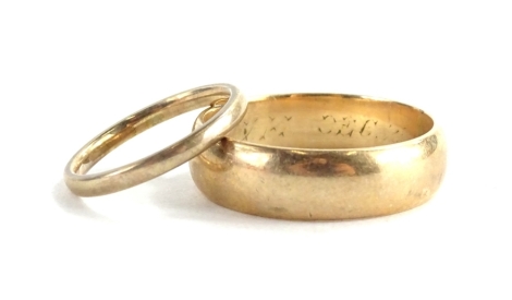 Two 9ct gold wedding bands, each of plain design, ring sizes Y and K, 8.7g all in, the larger ring bearing a partial engraving December 1920.