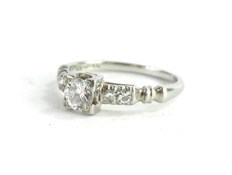 A small diamond ring, set in white coloured metal, stamped 18k.