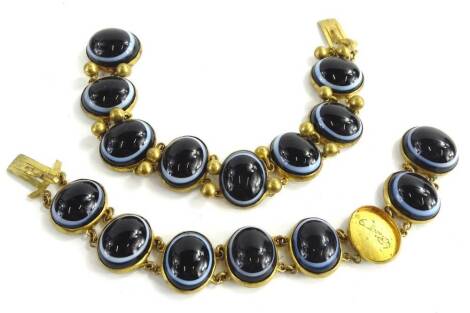 Two similar continental gilt metal bracelets, each mounted with black and white banded agate, and with gilt metal mounts. (AF)