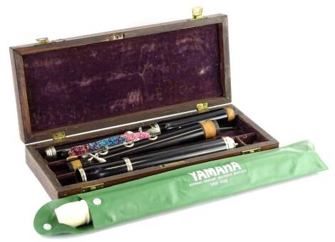 An ebonised wood and silver plated flute, in rosewood fitted case with vacant cartouche, and a Yamaha Soprano Baroque recorder. (2)