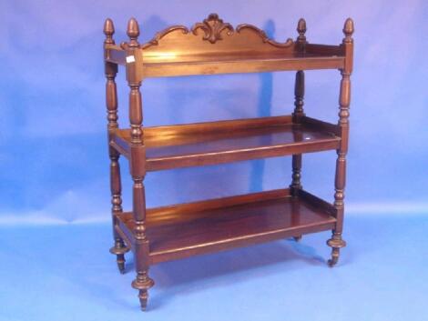 A Victorian mahogany 3 tier buffet stand with arched scroll gallery and