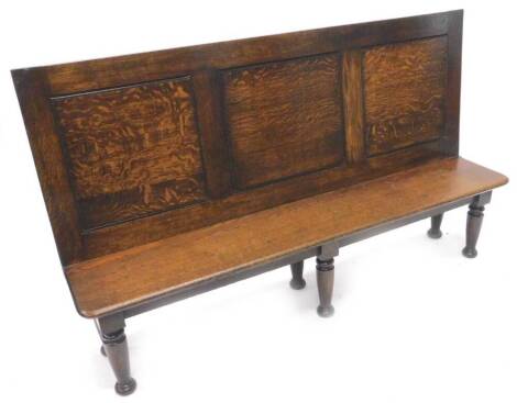 A panelled oak settle, with solid seat on turned legs, constructed using old timber, 169cm W.