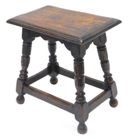 An oak joint type stool, the rectangular top, with a moulded edge on turned supports, 45cm W.