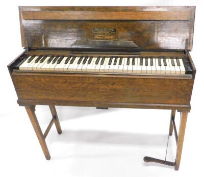A Dulcitone portable piano, in oak case, label for Dulcitone, patentees and maker Thomas Machell and Sons, Glasgow, Scotland, supplied by Crane and Sons Limited, numbered to frame 76829, 94cm W.