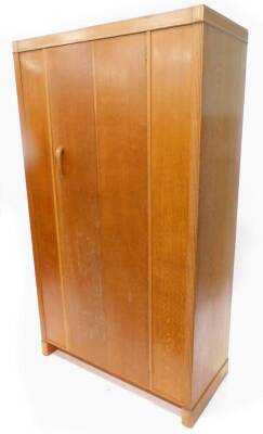 A retro light oak wardrobe, with single door, on block feet, 107cm W.