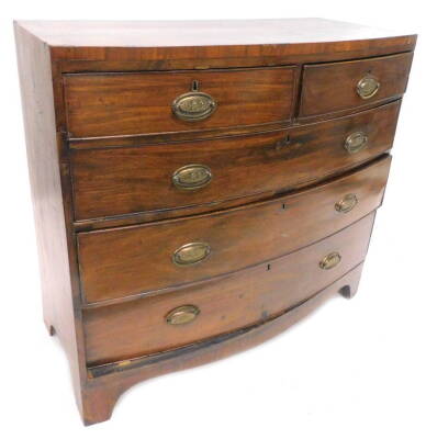 An early 19thC mahogany bow fronted chest of drawers, the caddy top above a two short and three long drawers, each with oval drop handles, on bracket feet, 107cm W.