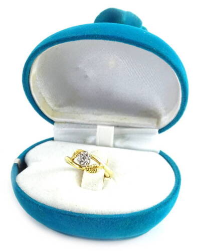 An 18ct gold diamond set floral ring, the diamond in illusion platinum setting, with curved leaf to each side, ring size N½, 3.1g, in a turquoise perfume bottle style ring box.