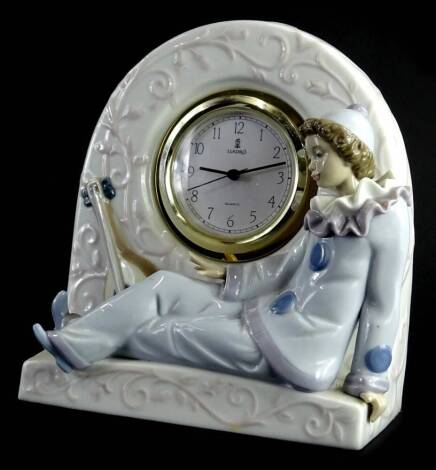 A Lladro clock group formed as a recumbent clown, with arched back and 7cm dia dial, printed marks beneath.