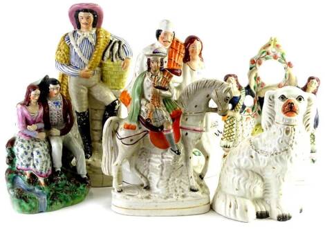 Various 19thC Staffordshire figures, to include a clock group, figure of a lady and gentleman in Highland dress, 29cm H, another figure aside basket of fish, further clock group, etc. (a quantity)