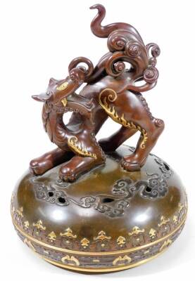 A fine Japanese two-colour patinated bronze koro, with gilt piquet work embellishments, silvered inlays and aplliques of coral and mother-of-pearl, the pierced and domed cover having Kylin surmount, dragon banded insert, the two-handle bulbous body with s - 15