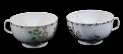 A pair of Chinese porcelain tea cups, decorated with European figures and a priest within a classical landscape below a rose swag border, 9cm H.