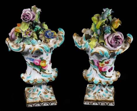 A pair of late 18thC continental porcelain baskets, each richly decorated with flowerheads, of inverted form on square gilt lined feet, polychrome decorated and handpainted with flowers to each vase, unmarked, 7cm H. (2)