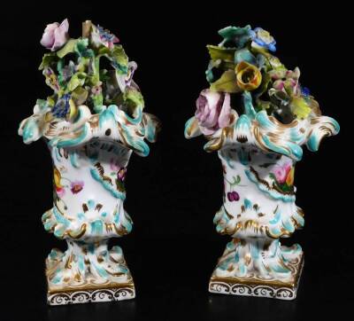 A pair of late 18thC continental porcelain baskets, each richly decorated with flowerheads, of inverted form on square gilt lined feet, polychrome decorated and handpainted with flowers to each vase, unmarked, 7cm H. (2) - 2