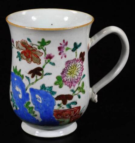 An 18thC Chinese porcelain baluster tankard, polychrome decorated with a hollyhock pattern landscape, 15cm H.