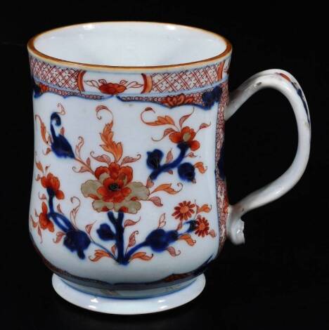 A large Chinese porcelain Imari pattern baluster tankard, decorated with a peony within a cell and crossed hatch border, 15cm H.