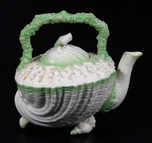 A Belleek 2nd period porcelain Nautilus pattern tea kettle, decorated in green, black Belleek mark, 16cm H. (2)