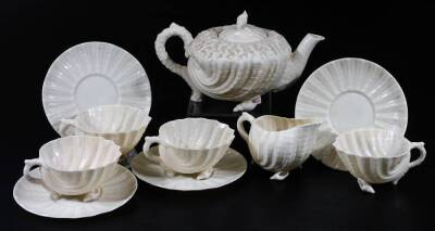 A Belleek 2nd period porcelain part Nautilus pattern tea set, comprising teapot and cover on shell feet, four cups and saucers and creamer, black marked. (a quantity)