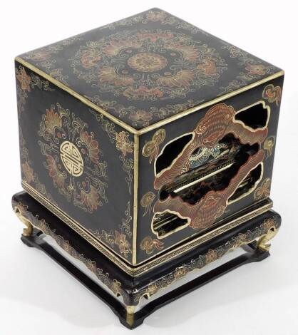 An early 20thC lacquered dowry chest, decorated with gilt oriental designs, raised on four feet, containing various boxes, etc.