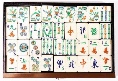 A Chinese wooden and painted table cabinet, enclosing six drawers containing a bone Mah-jong set to include tiles, counters etc. 17cm H. - 8