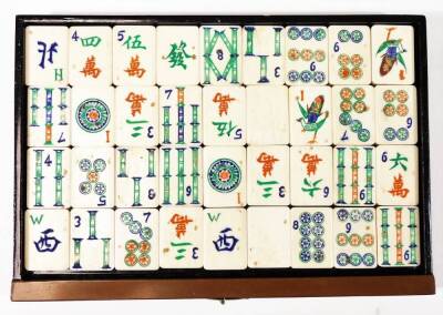 A Chinese wooden and painted table cabinet, enclosing six drawers containing a bone Mah-jong set to include tiles, counters etc. 17cm H. - 10