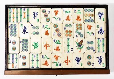 A Chinese wooden and painted table cabinet, enclosing six drawers containing a bone Mah-jong set to include tiles, counters etc. 17cm H. - 11