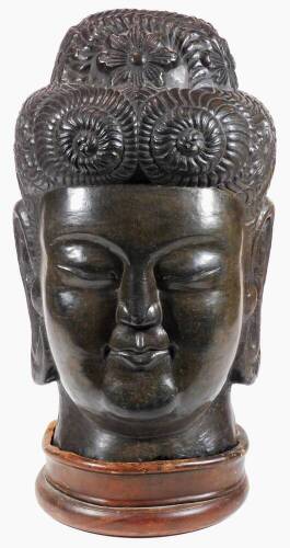 A large 20thC bronzed Chinese head sculpture, the figure with elaborate head dress and enlarged ears, on a removable wooden plinth base, 54cm H.