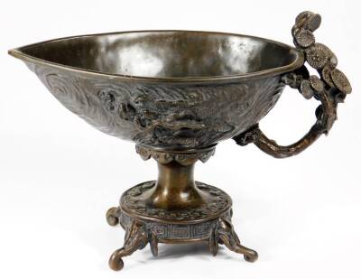 A Chinese patinated bronze vessel, with ellipse shaped bowl raised with geometric and floral patterns, with a floral handle on an inverted stem and circular foot, terminating in scroll feet, 18cm H. - 3