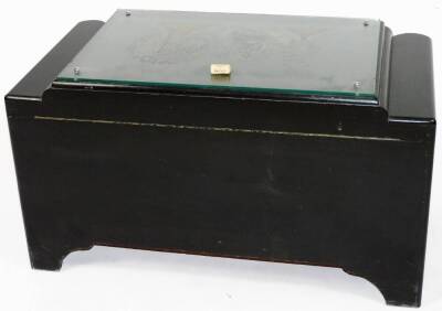 A 20thC Chinese lacquer camphor wood chest, of shaped rectangular form, the glass top revealing a heavily carved panel section of buildings, figures and boats, with a heavily carved front and lock, c1957, with key and receipt of sale, 50cm H, 93cm W, 52cm - 4