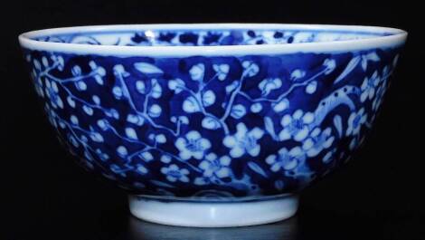 A Chinese porcelain prunus bowl, of circular form, profusely decorated to the exterior with leaves, trees and flowerheads, with further interior decoration similar, on circular foot, initial and dot mark beneath, 12cm dia.