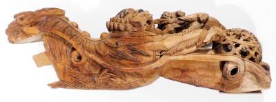 A matched pair of Chinese wooden carvings, of a dragon and young, heavily carved and picked out in black, 70cm H, and another similar. (2) - 5