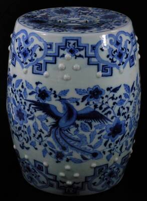 A 20thC Chinese Qing style porcelain barrel seat, of cylindrical form, partially pierced, in blue and white with an upper geometric style pattern, the top profusely decorated with flowers, with a raised upper banding, 46cm H, 31cm Dia.