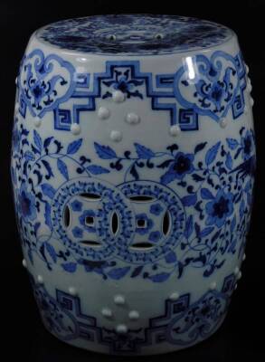 A 20thC Chinese Qing style porcelain barrel seat, of cylindrical form, partially pierced, in blue and white with an upper geometric style pattern, the top profusely decorated with flowers, with a raised upper banding, 46cm H, 31cm Dia. - 4