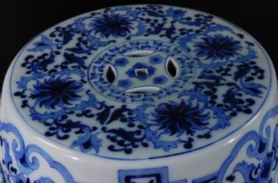 A 20thC Chinese Qing style porcelain barrel seat, of cylindrical form, partially pierced, in blue and white with an upper geometric style pattern, the top profusely decorated with flowers, with a raised upper banding, 46cm H, 31cm Dia. - 5