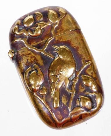 A Japanese polished brass vesta case, of oblong form raised with bird on elaborate tree bough, unmarked, 5cm H.