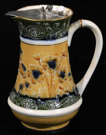 A James Macintyre & Co pewter lidded milk jug, decorated with tube lined flowers on a cream ground below a green and blue border, James Macintytre & Co back stamp RN 308931 and impressed mark, 15cm H.