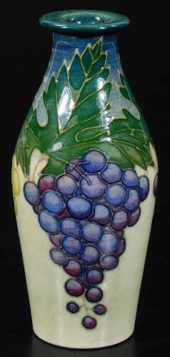 A Dennis China Works grape vase, decorated with green and white grapes and vine leaves on a cream ground, marked D.C.M. 2002F RMc S.T. des, 12cm H.