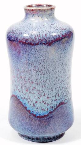 A 20thC Moorcroft pottery Cobridge test vase, the waisted shaped vase decorated in a mottled blue and red glaze, impressed Moorcroft, 22cm H.